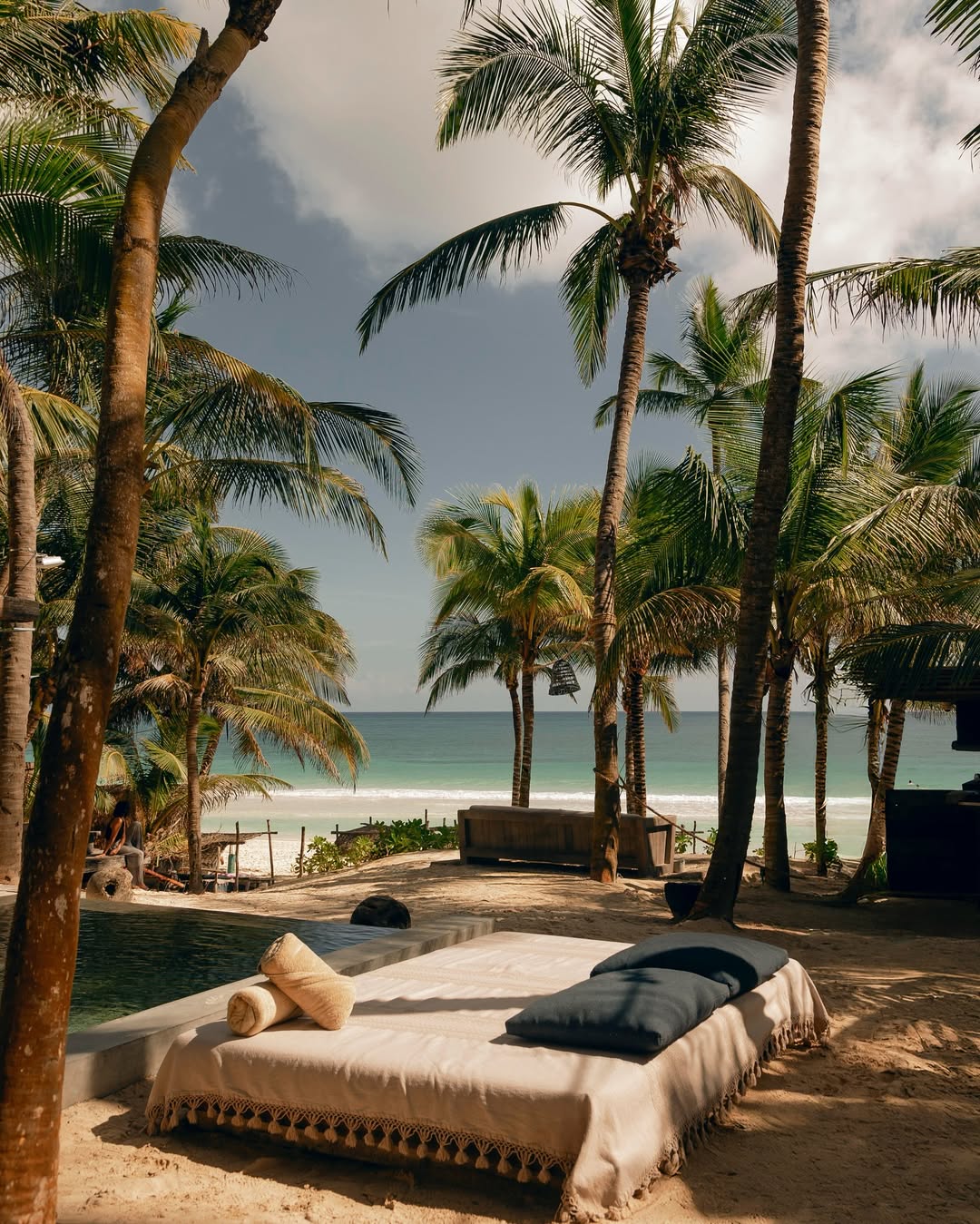 Beachfront wedding setup at Be Tulum, featuring a dreamy coastal backdrop with palm trees, perfect for intimate Tulum wedding venues.
