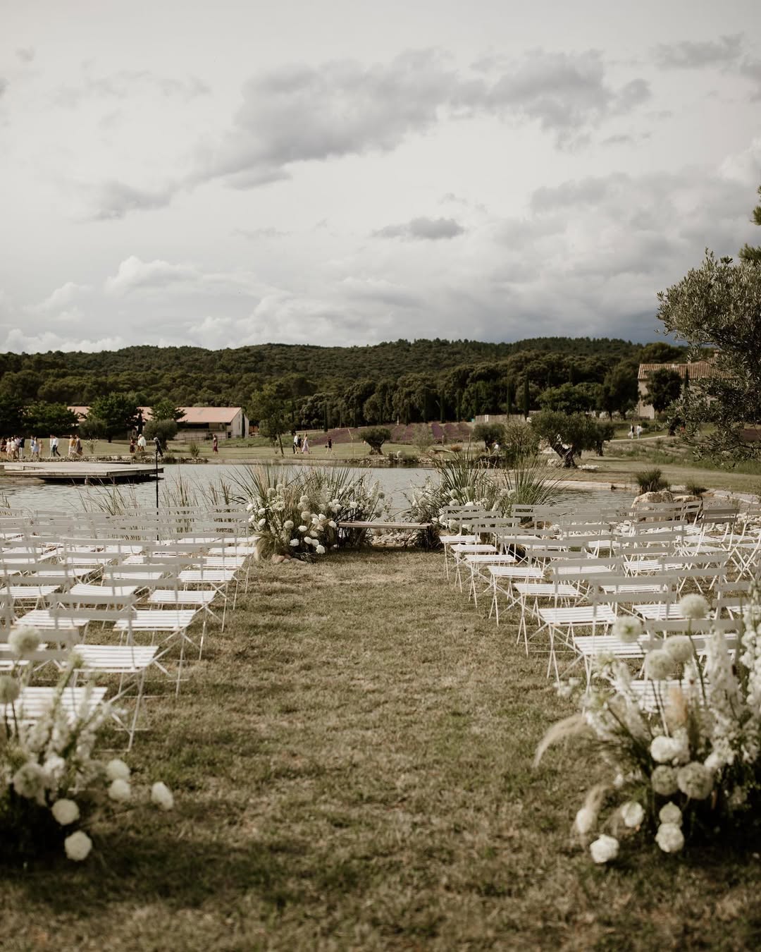 Rustic outdoor wedding ceremony overlooking a peaceful lake at Domaine de Patras, ideal for a serene and nature-inspired Provence France wedding.