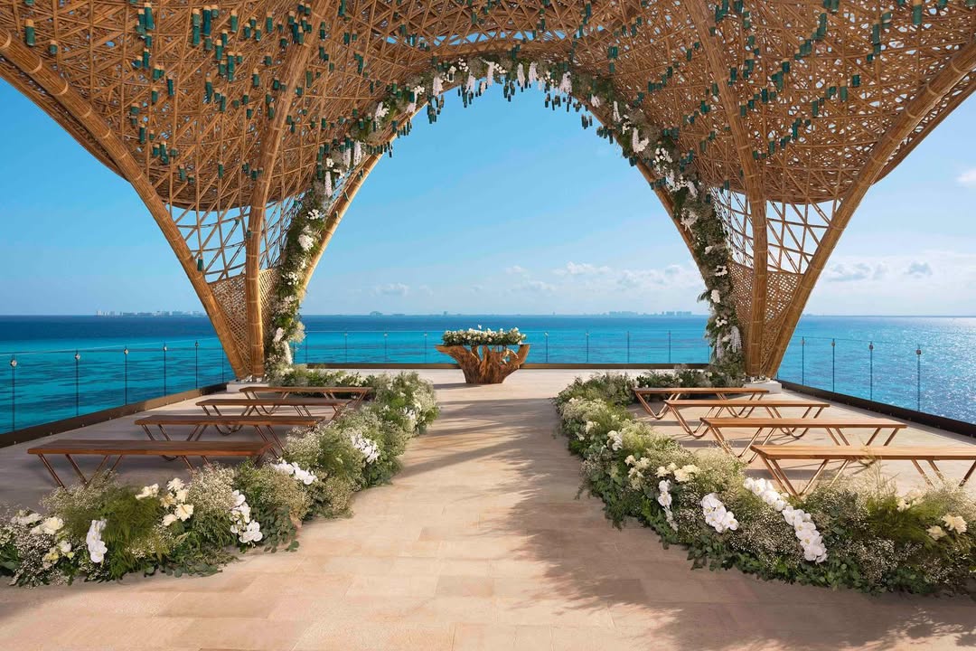 Elegant beachfront ceremony setup at Impression by Secrets, a luxury venue perfect for an Isla Mujeres wedding overlooking the Caribbean Sea.