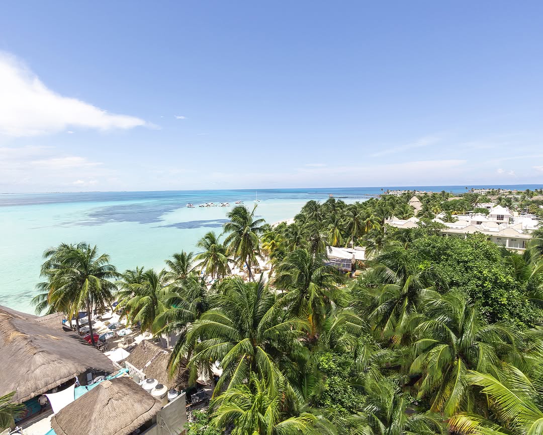 Aerial view of the turquoise shoreline near Ixchel Beach Hotel, a top beachfront venue for an unforgettable Isla Mujeres wedding.
