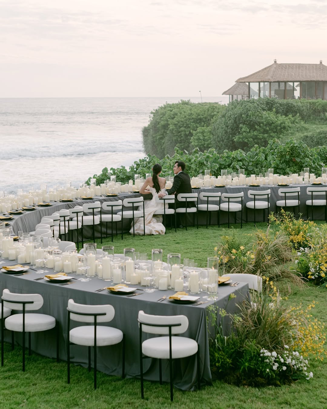 Cliffside Bali island wedding reception with ocean views and long candlelit dinner setup at Soori Bali.