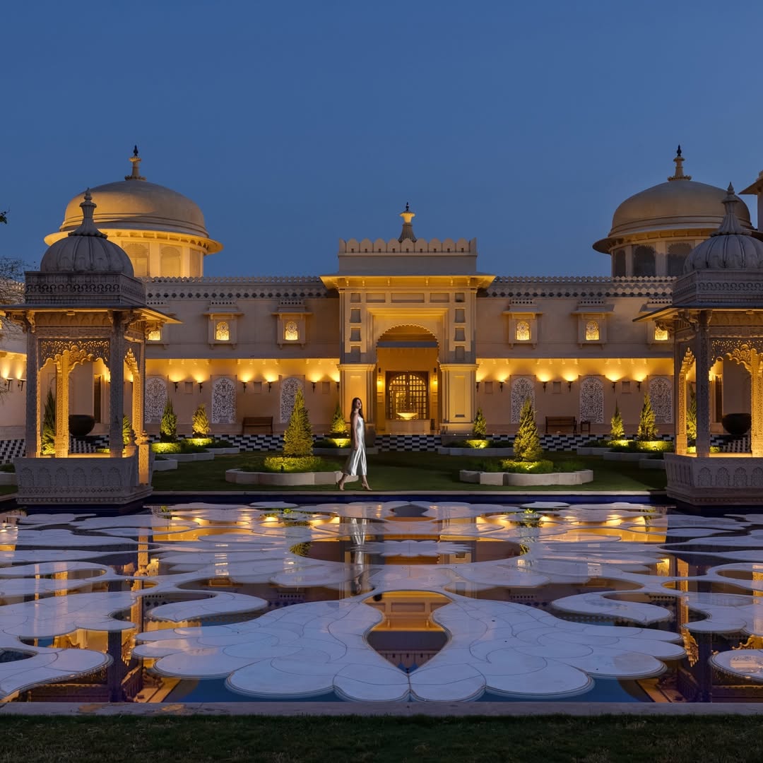 Majestic palace facade and reflection pool at The Oberoi Udaivilas, one of the most opulent wedding venues in Udaipur.