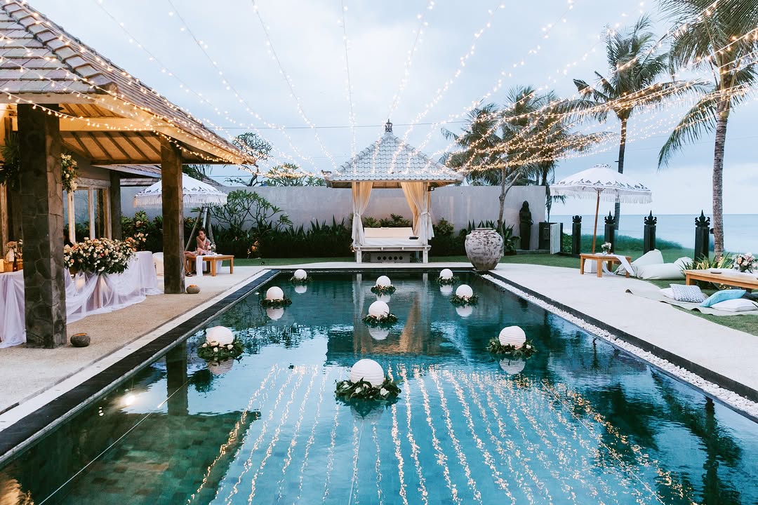 Chic Bali island wedding villa with poolside altar and fairy lights at The Royal Purnama beachfront resort.