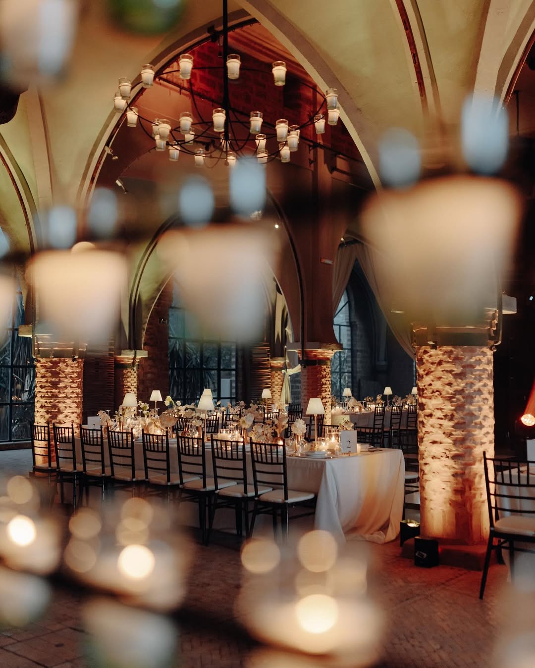 Romantic indoor wedding reception at Beldi Country Club, one of the most atmospheric Marrakech wedding venues featuring arched ceilings, candlelight, and rustic elegance.
