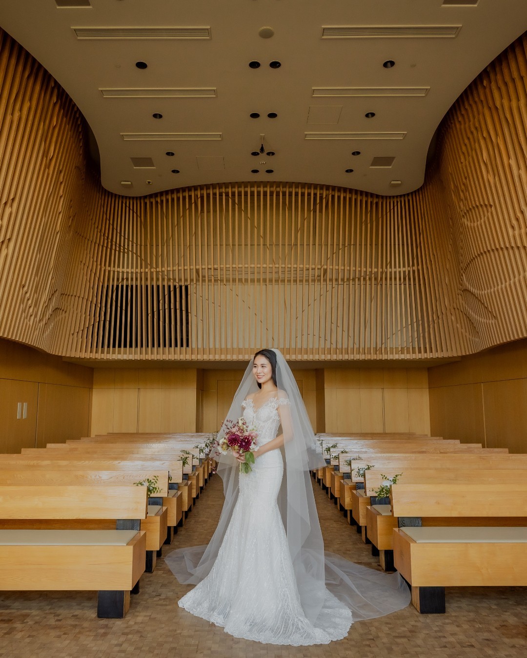 Elegant wedding reception setup at Four Seasons Hotel Kyoto, showcasing golden lighting, banquet tables with floral centerpieces, and luxurious decor—perfect for upscale Kyoto wedding venues.