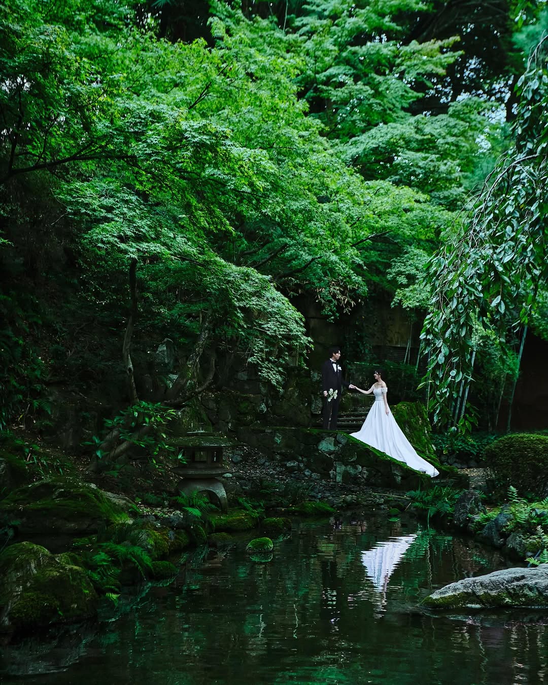 Glamorous indoor wedding reception at Hyatt Regency Kyoto with golden ambient lighting, indoor trees, and elegantly decorated tables—one of the most refined Kyoto wedding venues.