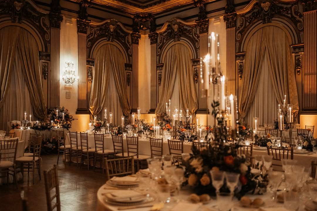 Lavish ballroom of Palazzo Brancaccio in Rome decorated with gold accents, candlelight, and floral arrangements—ideal for luxurious Rome wedding venues.